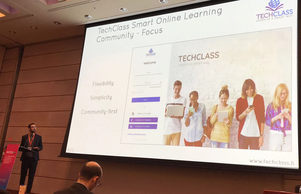 A TechClass presenter sharing the platform on stage at an international education-technology conference
