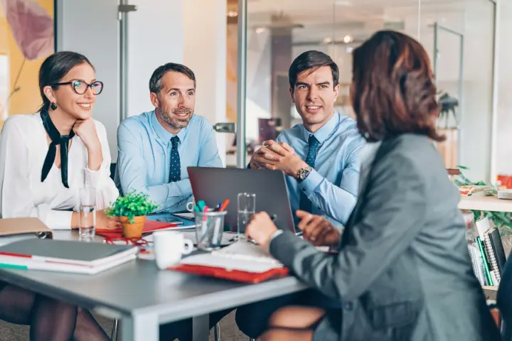 Managers reviewing team completion together in a meeting